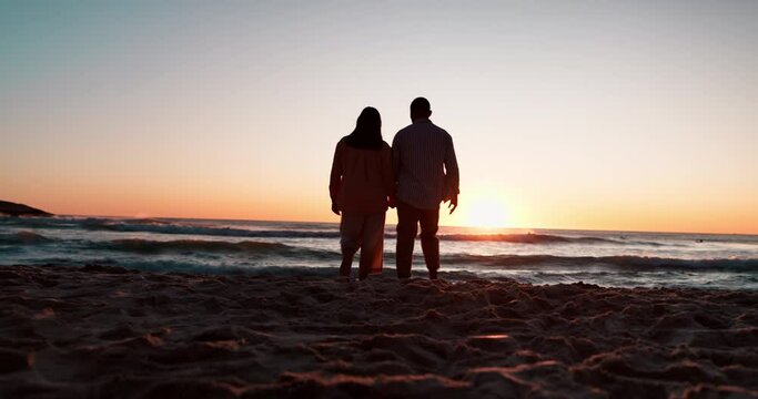 Silhouette, holding hands and sunset with couple at beach for travel, summer vacation and romance. Relax, love and holiday with man and woman walking on seaside date for commitment or care together