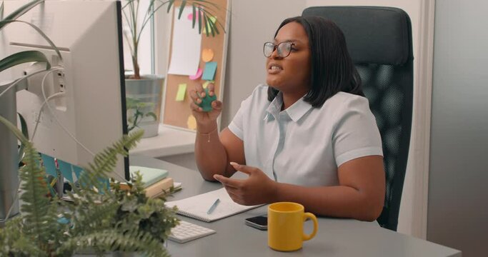 Angry woman office manager throwing stress ball, breathing deep to calm down at workplace. Concept of overwork. girl cannot cope with negative emotion, reliving anger, frustration Slow motion
