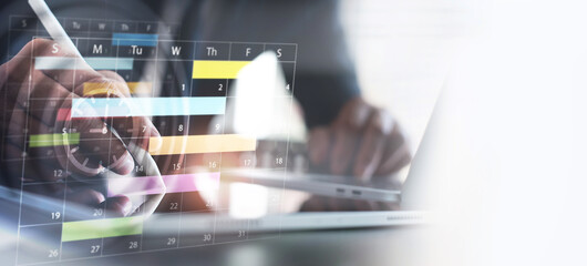 Close up of businessman using digital tablet with calendar planner and organizer to plan and reminder daily appointment, meeting agenda, schedule, timetable, and management, event planning