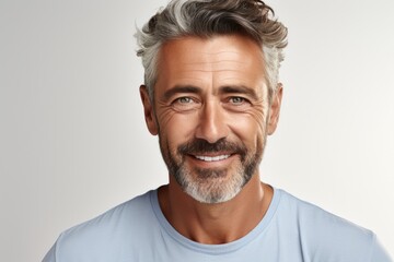 Fototapeta premium Handsome middle age man with beard wearing casual clothes over light background. Happy face smiling, looking at the camera. Positive person.