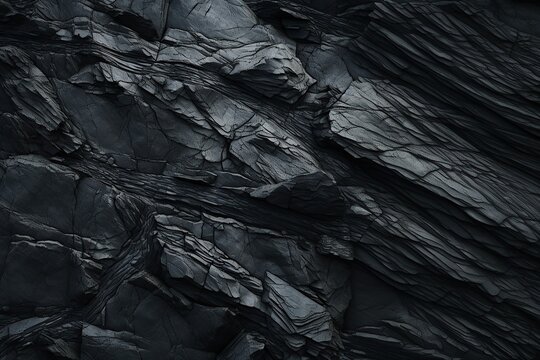 Black rock texture. Rough mountain surface with cracks. Close-up. Stone background with space for design.