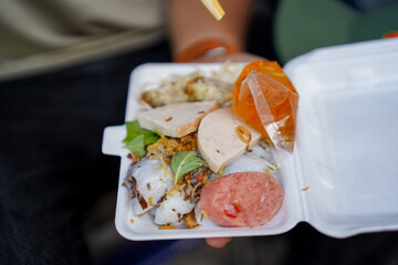 Take away traditional Vietnamese dish - Banh Cuon, Vietnamese steam rice rolls with fish sauce and vegetables. Selective focus.