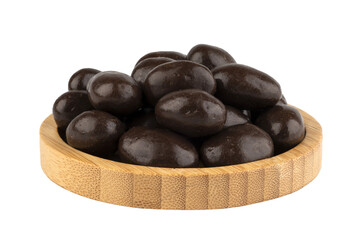 dark chocolate almond dragees in a wooden bowl