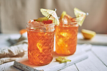 orange juice and oranges on white background