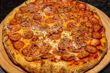 Traditional rustic pizza with pepperoni, black olives, onion and basil