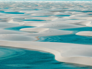 Aerial view of Lencois Maranhenses. White sand dunes with pools of fresh and transparent water....