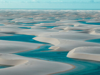 Aerial view of Lencois Maranhenses. White sand dunes with pools of fresh and transparent water....