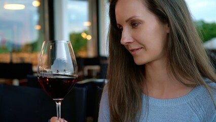 Woman drinking tasting red wine