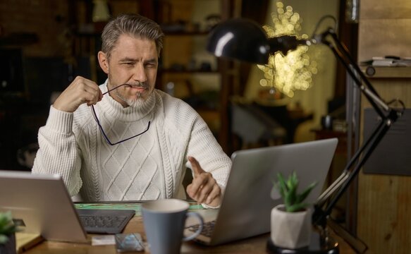 Man working online with computer in home office