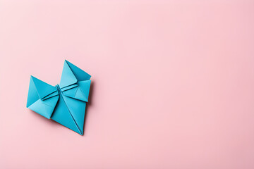 Blue origami heart on pink with copy space