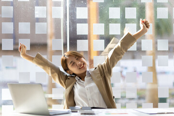 Businesswoman working in an office stretches to relax from work during breaks.