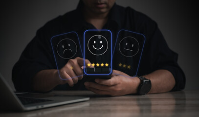 Business man use his finger to touching or pressing the virtual screen the smiley happy face with star to show satisfaction or the service or give rate. Concept of satisfaction and customer service.