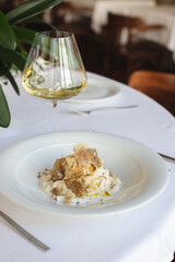 Restaurant serving dishes, waiter, banquet, set table with white tablecloth and chic dish.