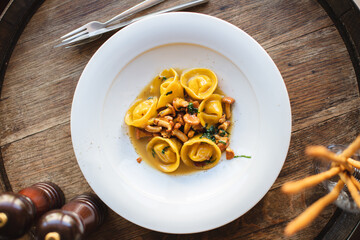 Appetizing ravioli with mushrooms in a white plate. Restaurant, banquet, menu