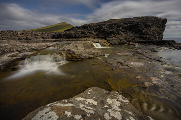 Small waterfalls at slave cliff and floating lake, Traelanipa, Sorvagsvatn, Vagar, Faroe Islands 