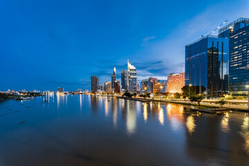 Aerial view of Bitexco Financial Tower building, Century Link, train tracks, buildings, roads, and Saigon river