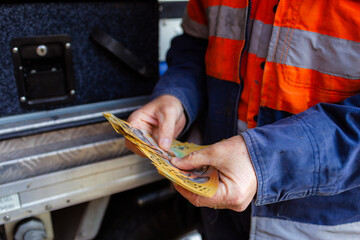 Male tradie counting cash payment for job paid in cash