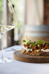 Appetizing bruschetta with cream cheese, microgreens and mushrooms.