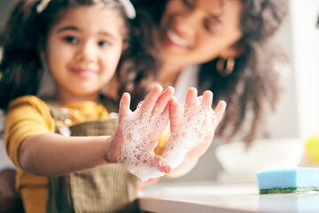 Soap, cleaning hands and family with child in bathroom for learning healthy hygiene routine at home. Closeup, mom and girl kid washing palm with foam for safety of bacteria, dirt or germs on skincare - Powered by Adobe