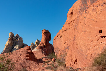 Scenic view of striated red and white rock formations along the White Domes Hiking Trail in Valley of Fire State Park in Mojave desert, Nevada, USA. Unique natural landmark shaped like a spire