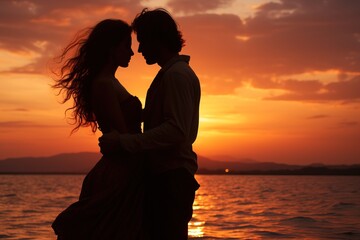 silhouette of lovers embracing couple man and woman against the backdrop of a beautiful sunset on the sea