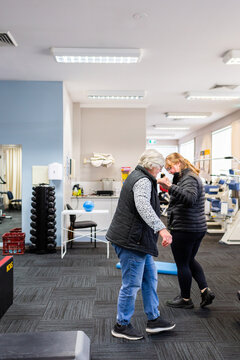 Woman doing balance practice with physio at physiotherapist clinic
