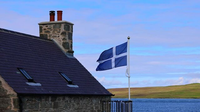 Shetland Flag waving on a typical medieval house in Lerwick downtown and port in Scotland, England. High quality 4k footage.