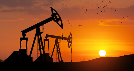 The change in oil prices caused by the war. Oil price cap concept. Oil drilling derricks at desert...