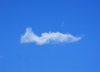 Fototapeta na wymiar Lonely white cloud on a blue summer sky
