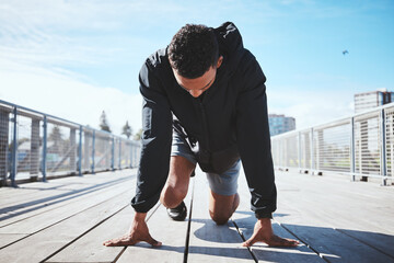 Fitness, running and a man at the start of his workout in the city for cardio or endurance...