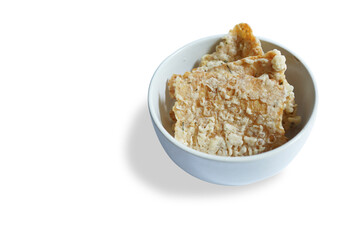 savory snack, tempeh chips in a white bowl on a plain background - Indonesian street food