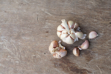 herbs. garlic on a wooden board ready to be processed. Top view, high resolution product.