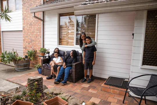 Aboriginal family sitting on outside chair