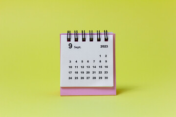 Calendar for September 2023 on a yellow background. Desktop calendar for planning and managing each date.