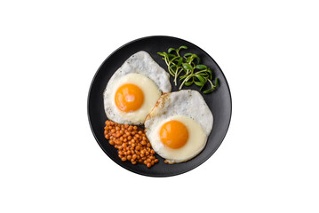 Delicious hearty breakfast consisting of two fried eggs, canned lentils and microgreens