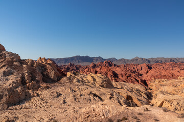 Fototapeta premium Scenic view of from Silica Dome viewpoint overlooking the Valley of Fire State Park in Mojave desert, Nevada, USA. Landscape of Aztek sandstone rock formations. Hot temperature in arid vegetation