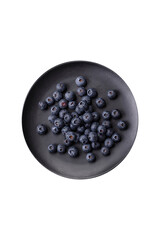 Delicious fresh blueberries on a textural black concrete background