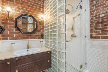 Bathroom interior with exclusive design. The room is decorated with brick tiles. Shower .cabin with...