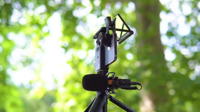Equipment for shooting video on a smartphone. Microphone, tripod, lens smartphone on outdoor
