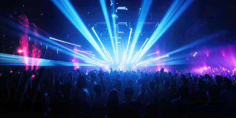 DJ mixing tracks on a booth in a nightclub with colorful lasers show. An amazing club atmosphere with a lof of people dancing to electronic music	
