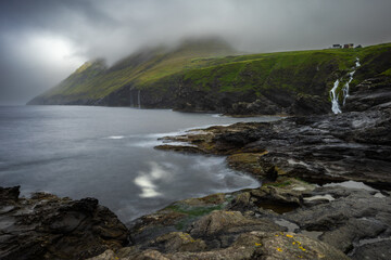 Waterfall below houses at Vidareidi, Faroe Islands