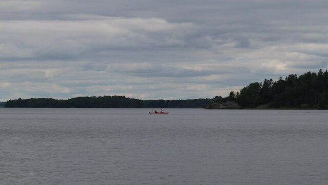 One orange canoe at the horizon. Mälaren lake, Sweden.