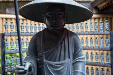 Fototapeta premium Japanese Buddhist statue hold stick with small Buddha decor