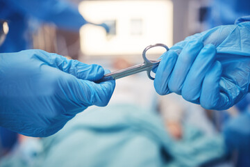 Hands, scissors for operation and teamwork in the hospital during surgery or emergency medical procedure. Collaboration, healthcare equipment and doctors in theatre together to save a patient closeup
