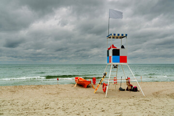 A deserted beach with a lifeguard tower