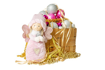wicker box with New Year's Christmas decorations - colorful balls and beads and a Christmas angel...