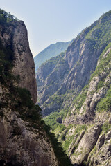 Fototapeta na wymiar Sunny day in canyon Moraca, Montenegro. River and deep canyon. Nature scenery.