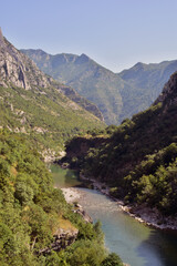 Fototapeta na wymiar Sunny day in canyon Moraca, Montenegro. River and deep canyon. Nature scenery.