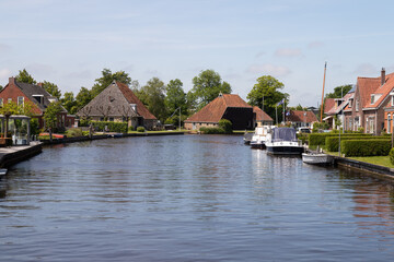 Fototapeta na wymiar View of the picturesque Dutch village of Terherne located near lakes in Friesland.