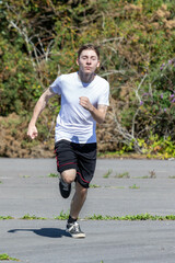 Teenage boy running during summer
